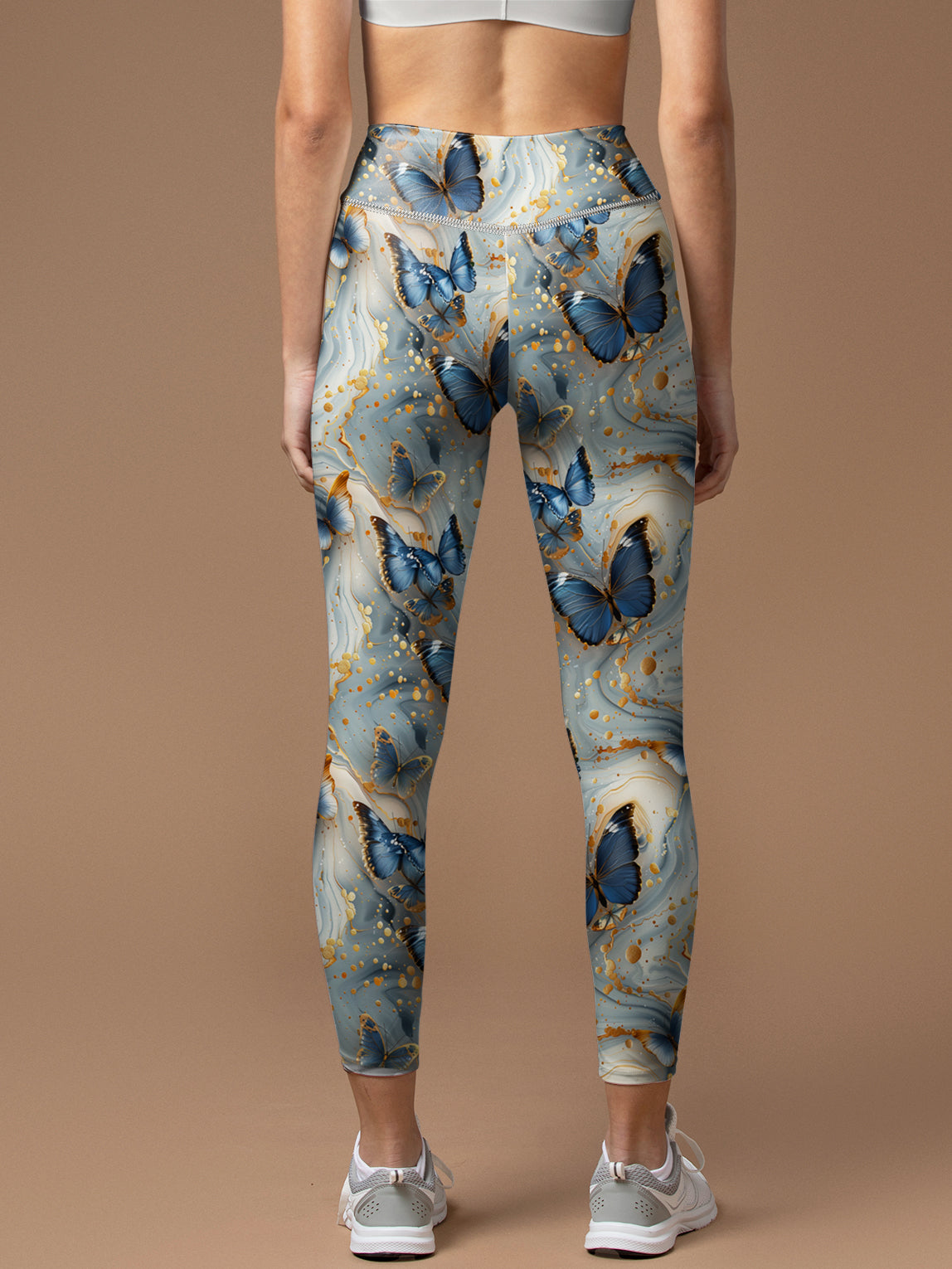 Butterfly floating in gilt water ripples leggings
