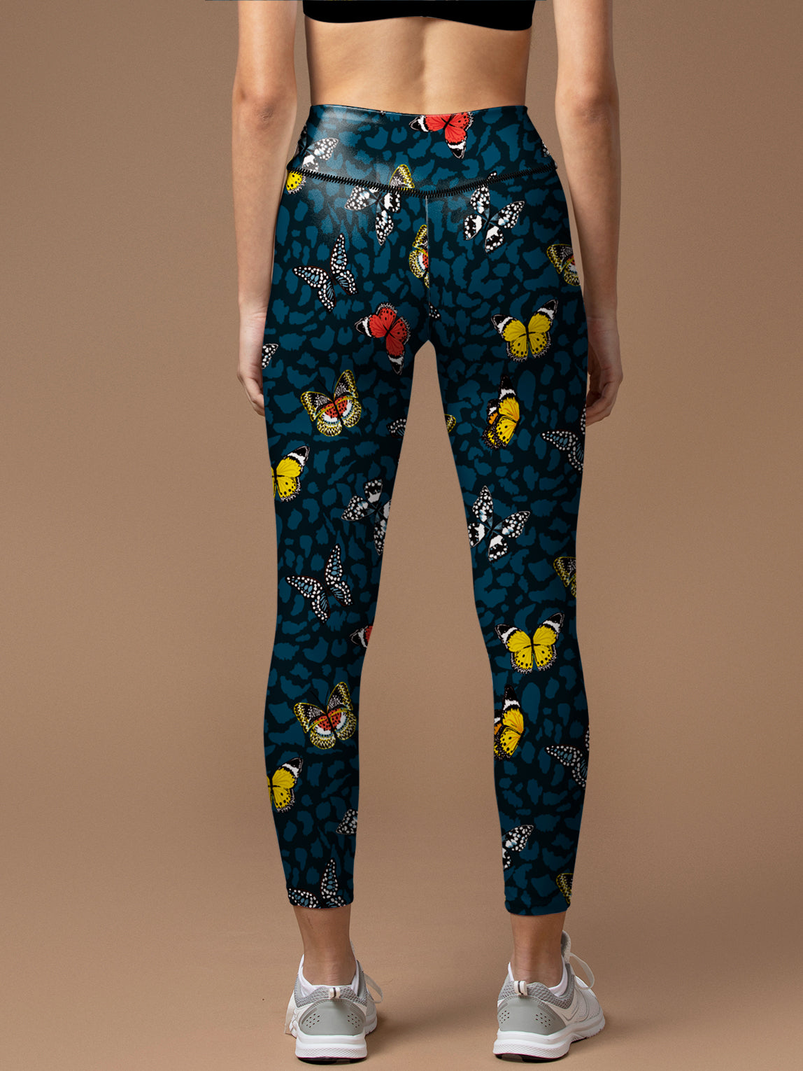 Colorful butterflies flying on animal skin leggings